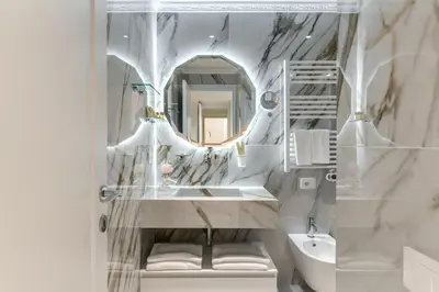 a white kitchen with white cabinets and a sink at Rome55 - Piazza di Spagna in Rome