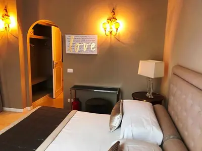 a bedroom with a bed and a table with a lamp at Di Rienzo Residences in Rome