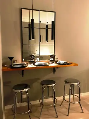 a table with three bar stools and a mirror at Di Rienzo Residences in Rome