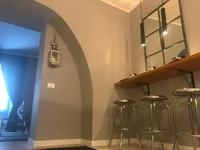 a room with stools and a wall with an arch at Di Rienzo Residences in Rome