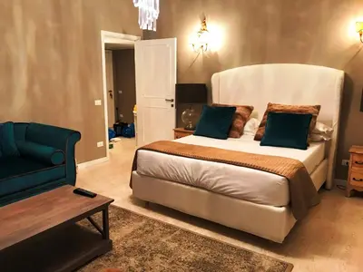 a bedroom with a large bed and a couch at Di Rienzo Residences in Rome