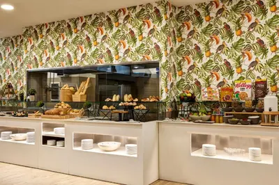 a bakery with a counter with food on display at Occidental Aurelia in Rome