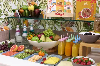 a table topped with bowls of fruit and juice at Occidental Aurelia in Rome