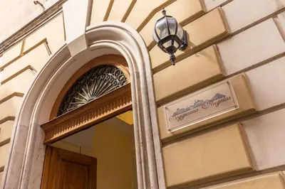 a sign on the side of a building with a mirror at Soggiorno Angelus in Rome