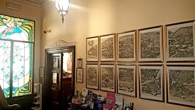 a room with a bunch of drawings on the wall at Soggiorno Angelus in Rome