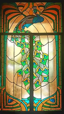 a stained glass window with a bird on top of it at Soggiorno Angelus in Rome