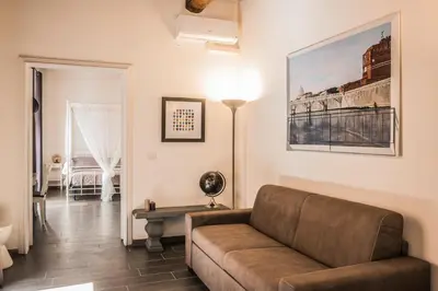 a living room with a couch and a lamp at Pantheon116 in Rome