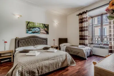 a bedroom with two beds and a window at Ariana Luxury Guest House in Rome