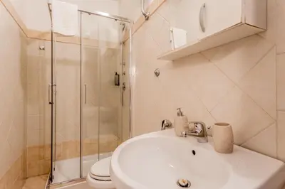 a bathroom with a sink and a shower at Ariana Luxury Guest House in Rome