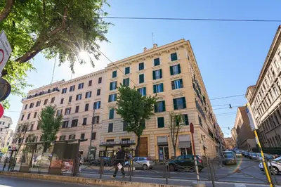 a large building on a city street with cars parked at New In! Sophie at Colosseum in Rome