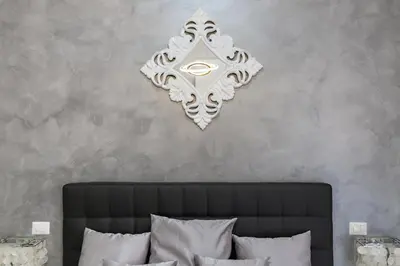 a wall decoration above a bed in a bedroom at New In! Sophie at Colosseum in Rome