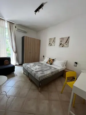 a bedroom with a bed and a yellow chair at Domus Amica in Rome