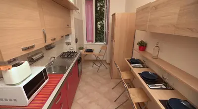 a kitchen with a microwave and a stove top oven at Domus Amica in Rome