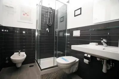 a bathroom with a toilet and a sink and a shower at B&B Home 77 in Rome