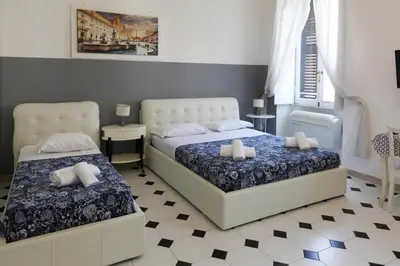 a bedroom with two beds and a checkered floor at Vatican Catone Apartments in Rome