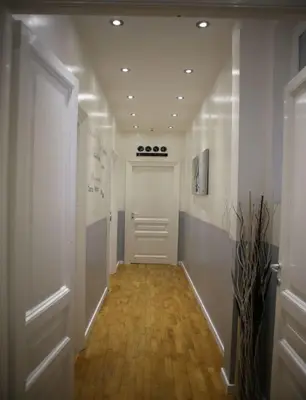 a hallway with a white door and a wooden floor at Vatican Catone Apartments in Rome