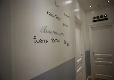 a bathroom with a wall with writing on it at Vatican Catone Apartments in Rome