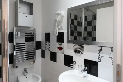 a bathroom with a sink and a mirror at Vatican Catone Apartments in Rome