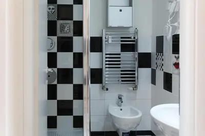a small bathroom with a sink and a mirror at Vatican Catone Apartments in Rome