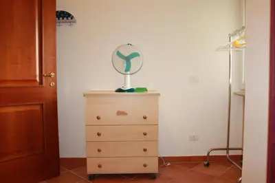 a dresser with a fan on top of it at A Casa Di Magda (Al centro di Roma) in Rome
