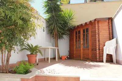 a patio with a table and a wooden door at A Casa Di Magda (Al centro di Roma) in Rome