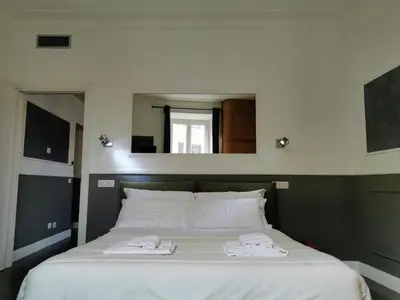 a bedroom with a bed with two towels on it at CoolHouse at Colosseo in Rome