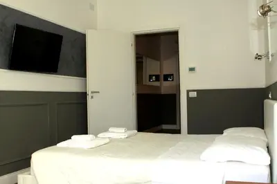 a bedroom with a bed with two towels on it at CoolHouse at Colosseo in Rome