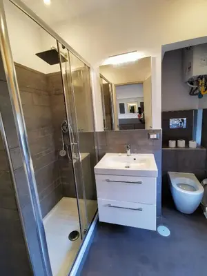 a bathroom with a shower and a sink and a toilet at CoolHouse at Colosseo in Rome