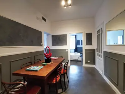 a dining room with a wooden table and chairs at CoolHouse at Colosseo in Rome