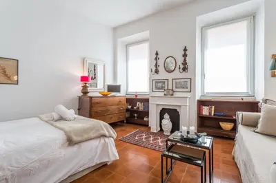 a living room with a bed and a fireplace at Sora Menica in Rome
