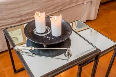 a glass table with two candles on top of it at Sora Menica in Rome