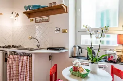 a small kitchen with a sink and a table at Sora Menica in Rome