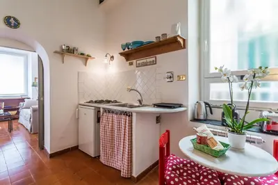 a kitchen with a table and a sink and a counter at Sora Menica in Rome