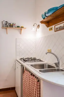 a kitchen with a sink and a stove at Sora Menica in Rome