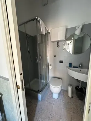 a bathroom with a shower and a toilet and a sink at Guest House Relais Indipendenza in Rome