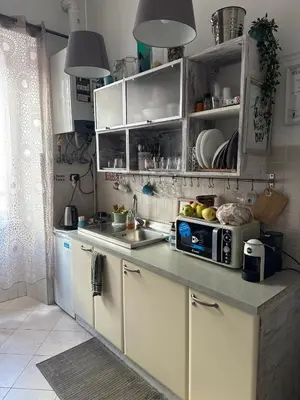 a kitchen with white cabinets and a sink at Guest House Relais Indipendenza in Rome