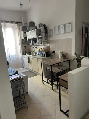 a kitchen with a table and a dining room at Guest House Relais Indipendenza in Rome