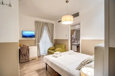 a hotel room with a bed and a couch at A Peace Of Rome B&B in Rome