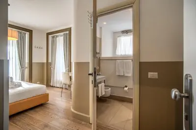 a hotel room with a bed and a bathroom at A Peace Of Rome B&B in Rome