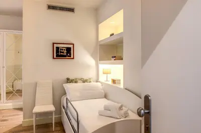 a small room with a bed and a chair at A Peace Of Rome B&B in Rome