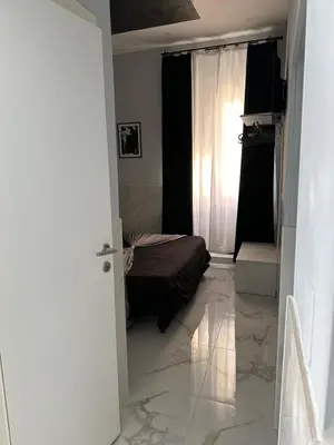 a bedroom with a bed in a room with marble floors at Italy Guest House in Rome