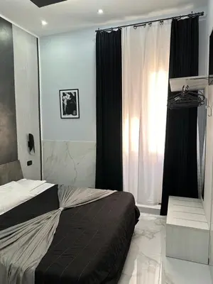 a bedroom with a bed and a window with curtains at Italy Guest House in Rome