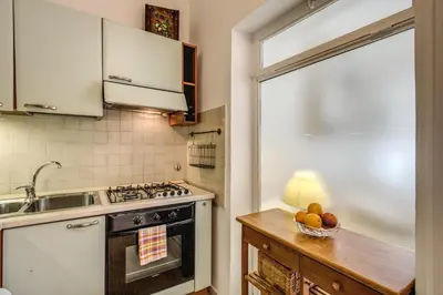 a kitchen with a stove top oven next to a sink at GuestHouse o Affittacamere Casa Fienaroli 2 in Rome