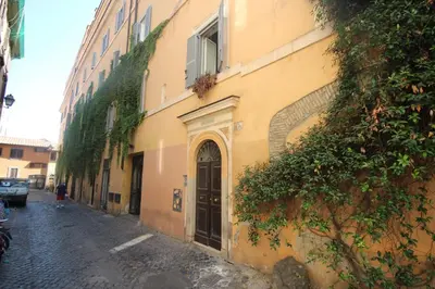 a woman walking down a street next to a building at GuestHouse o Affittacamere Casa Fienaroli 2 in Rome