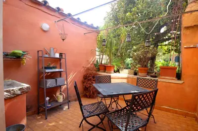 a patio with a table and chairs on a patio at GuestHouse o Affittacamere Casa Fienaroli 2 in Rome