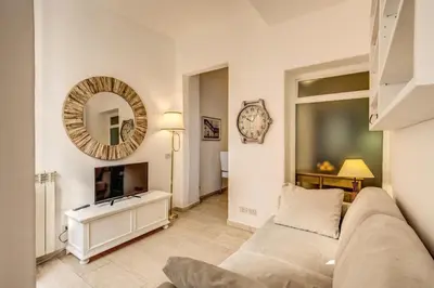 a living room with a couch and a tv at GuestHouse o Affittacamere Casa Fienaroli 2 in Rome