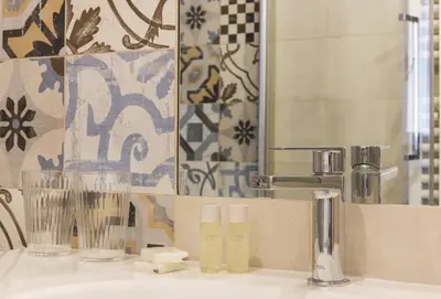 a bathroom with a sink with a mirror and a sink at Cozy apartment in via degli Spagnoli - FromHometoRome in Rome
