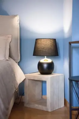 a lamp on a night stand next to a bed at Vatican's Sight in Rome