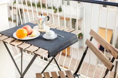 a table with a blender and fruit on a balcony at Vatican's Sight in Rome