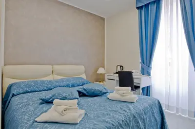 a bedroom with a bed with white socks on it at Oscar 2 in Rome